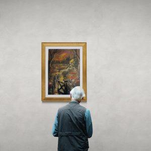 Elderly man looking at gallery wall (1)